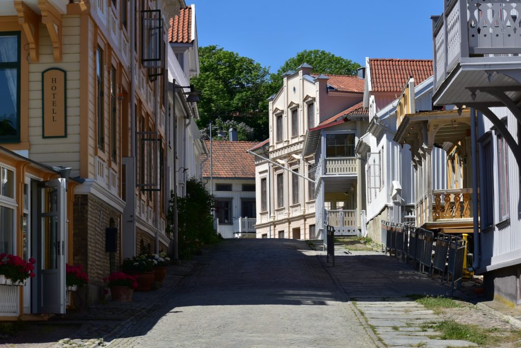 a narrow street lined with buildings and a clock tower